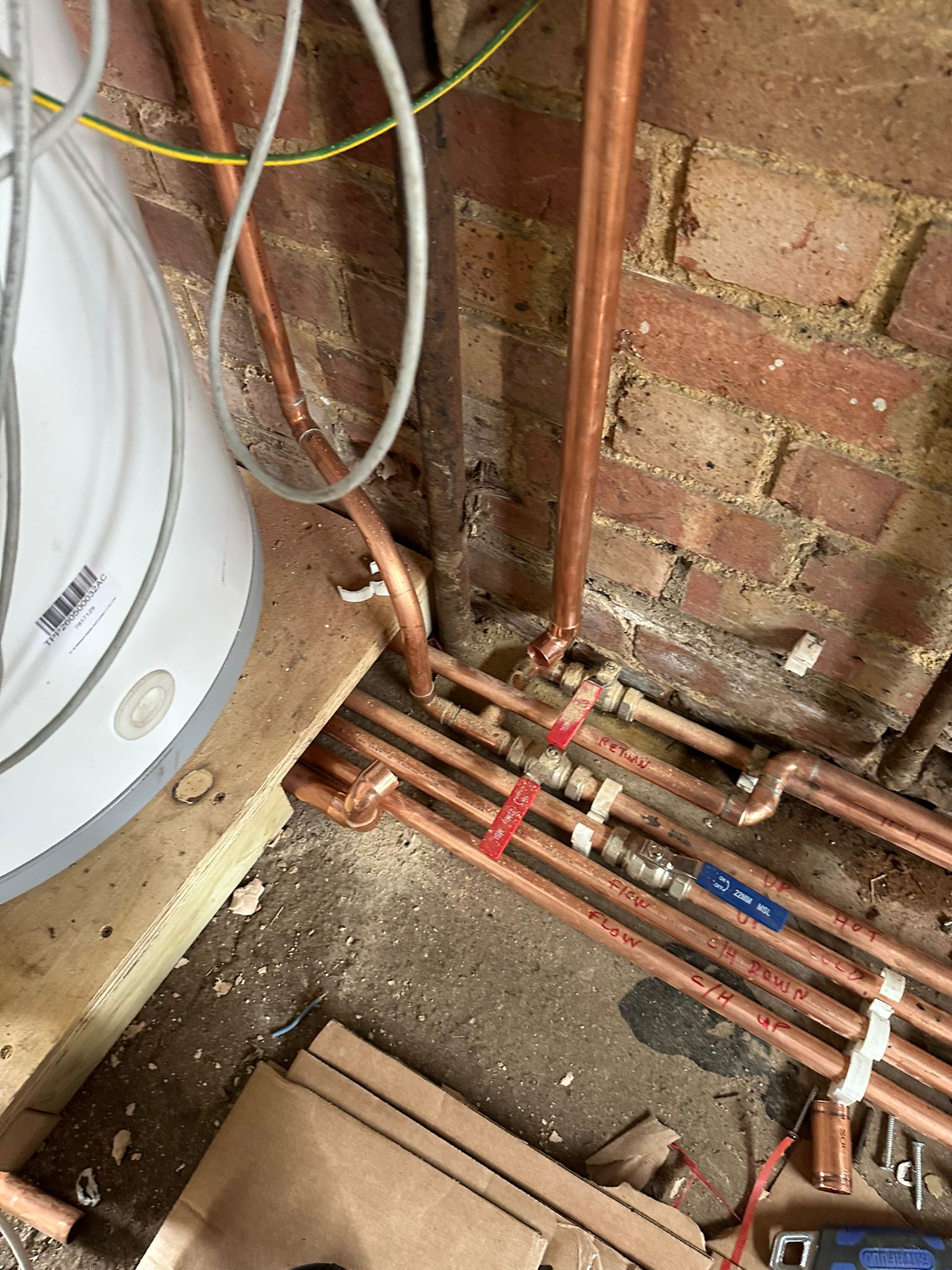 Labelled copper pipework with flow and return markings